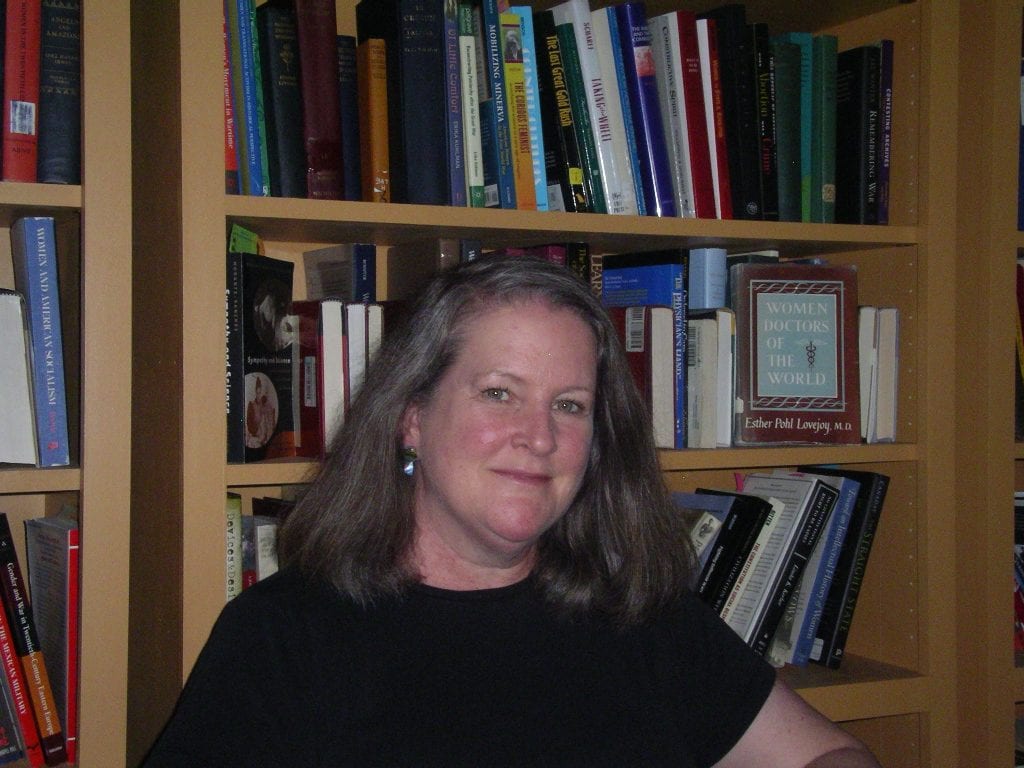 Kimberly Jensen in front of a bookcase